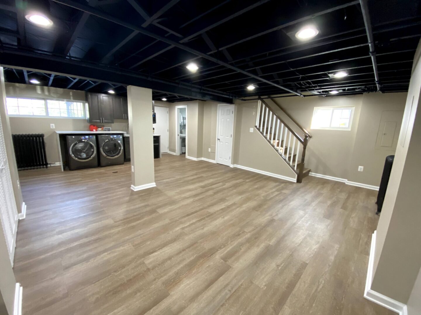 A room with black ceiling and wooden floors.