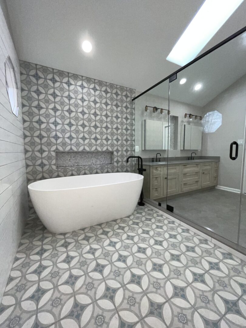 A bathroom with a tub, sink and mirror.