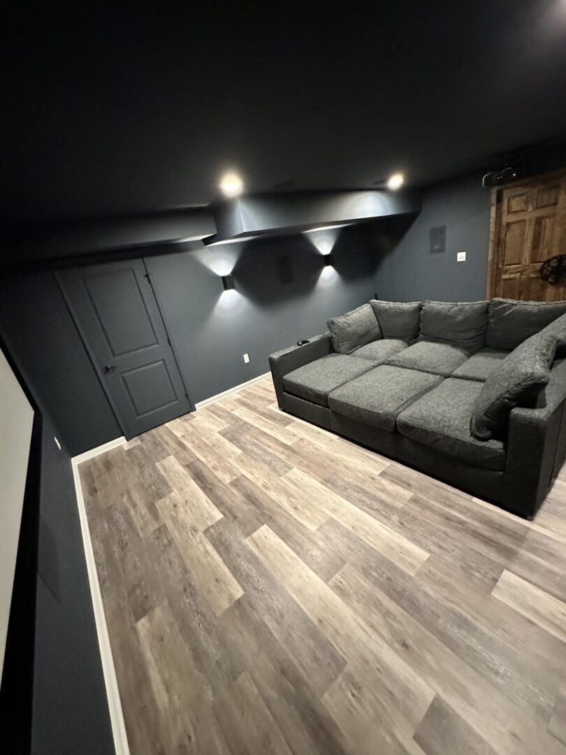 A room with a couch and lights on the wall