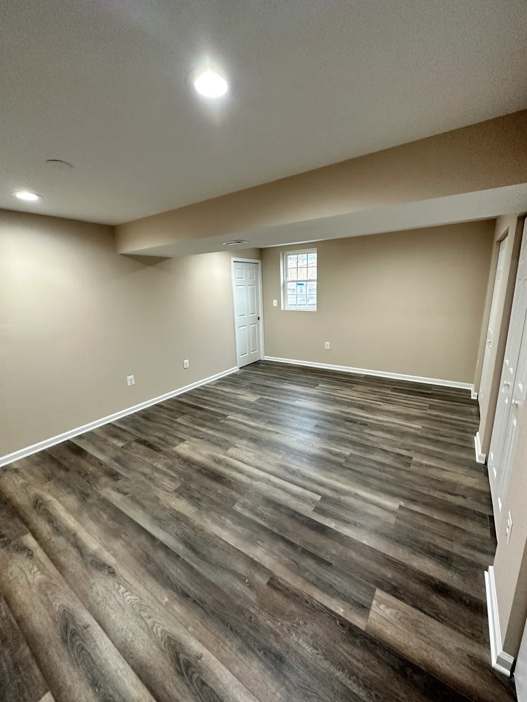 A room with wood floors and white walls.