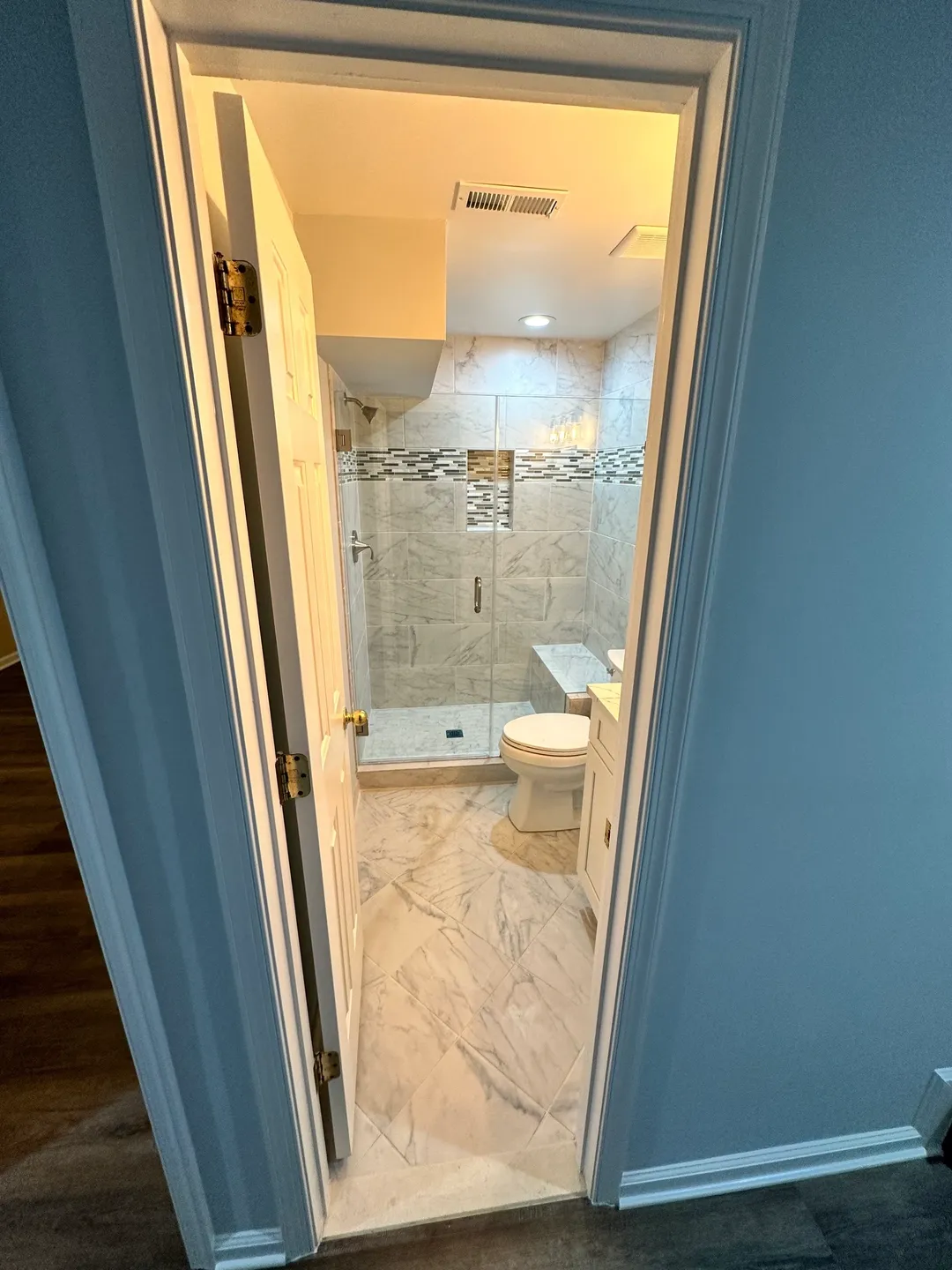 A bathroom with a toilet and shower in it