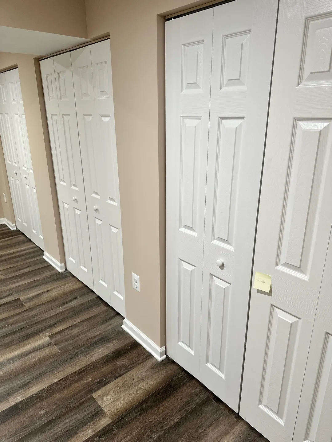 A row of white doors in a room.