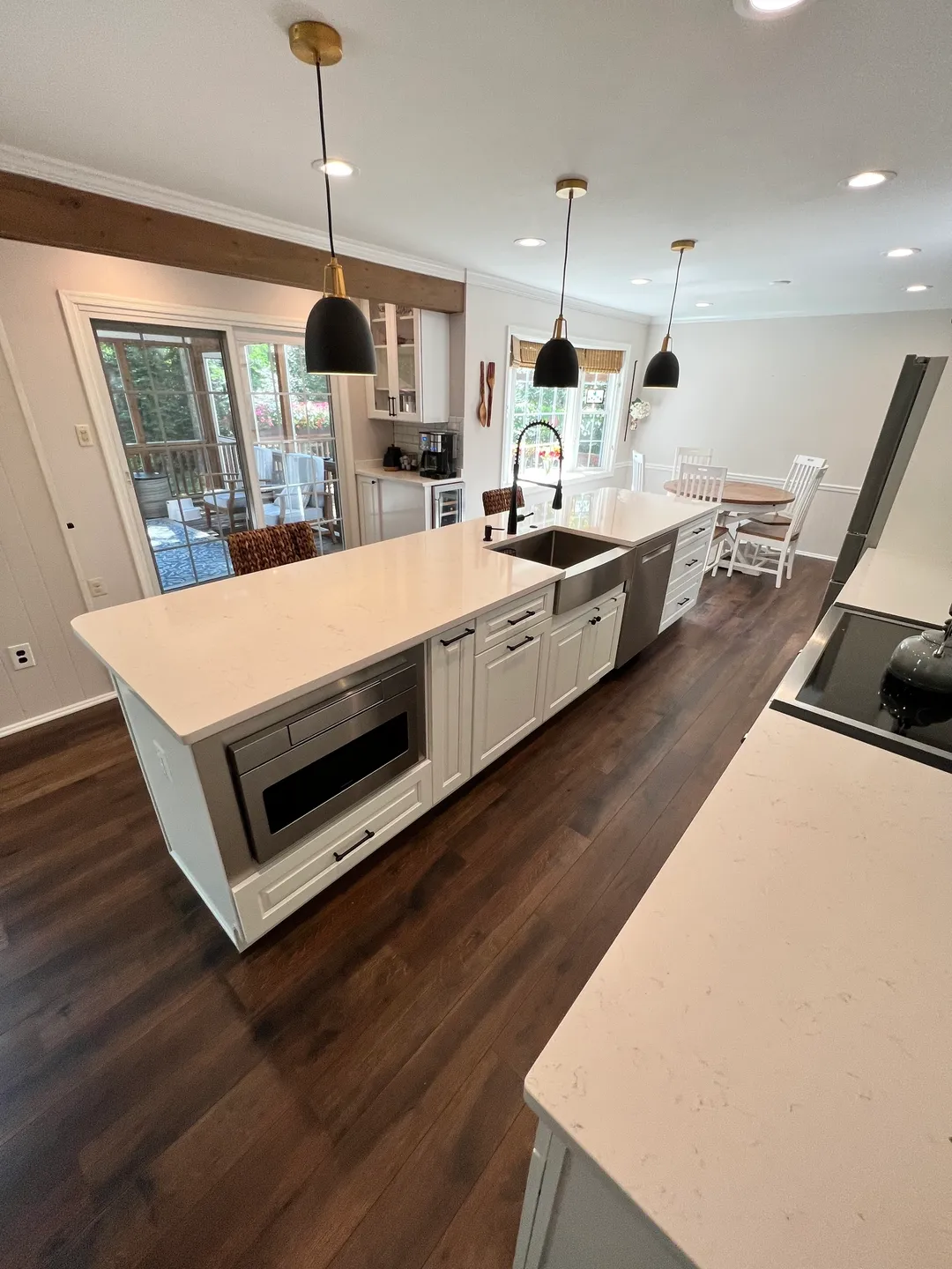 A kitchen with an island and wooden floors