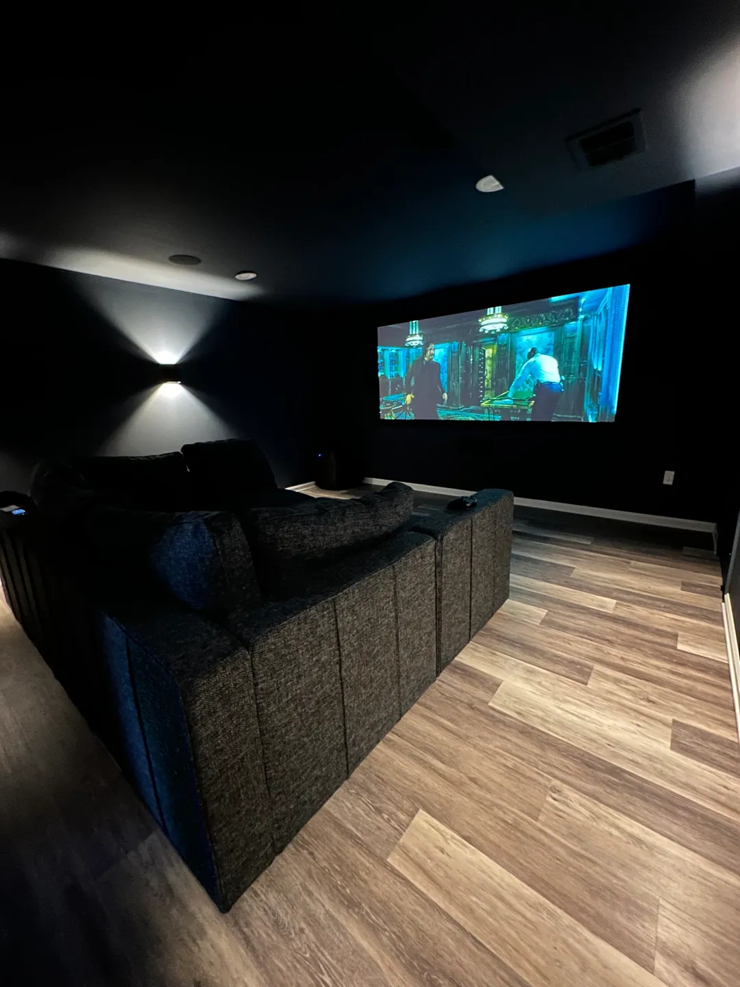 A room with a couch and a projector screen