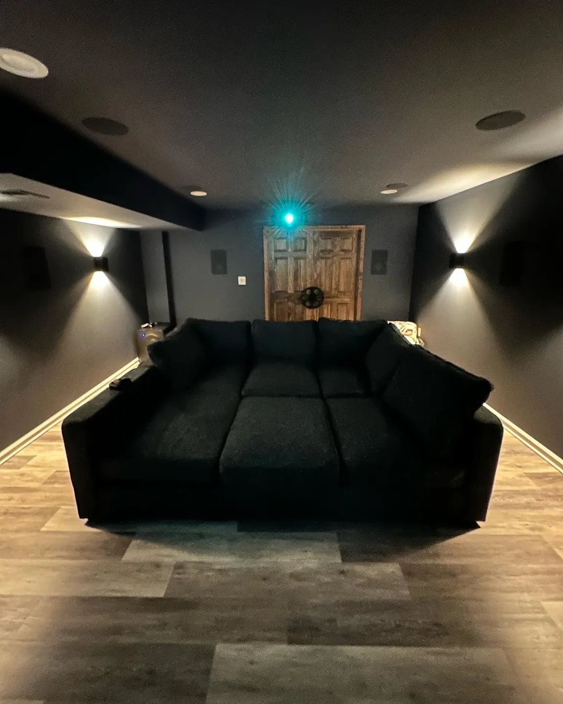A large black couch in the middle of a room.