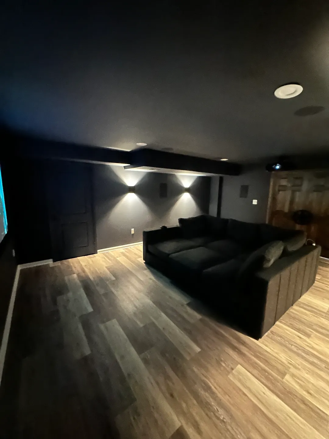 A large black couch in the middle of a room.